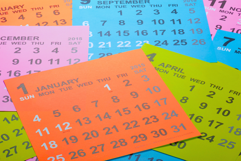 Months of a calendar scattered on a surface